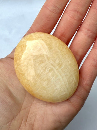 MANGO CALCITE PALM STONE (2) tumble stone The Crystal Avenues