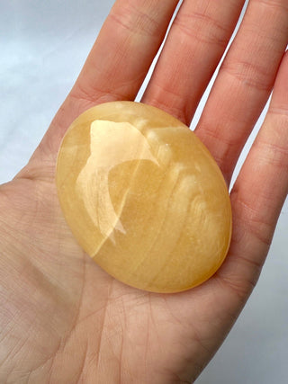 MANGO CALCITE PALM STONE (3) tumble stone The Crystal Avenues