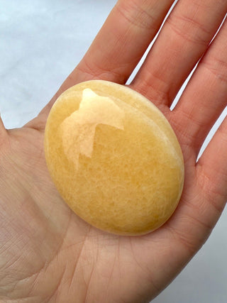 MANGO CALCITE PALM STONE (4) tumble stone The Crystal Avenues