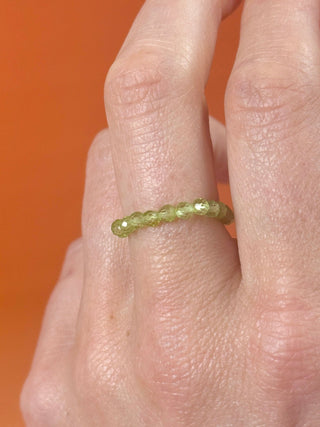 PERIDOT - CRYSTAL STRETCH RING WITH FACETED BEADS Bracelet The Crystal Avenues