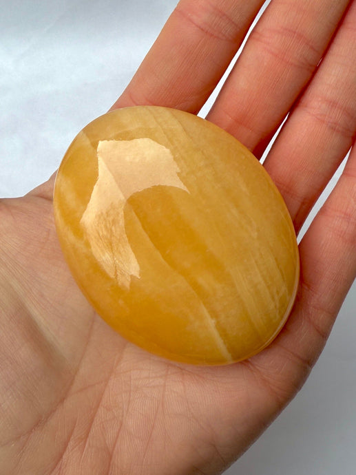 MANGO CALCITE PALM STONE (1) tumble stone The Crystal Avenues 