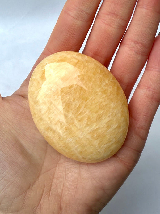 MANGO CALCITE PALM STONE (2) tumble stone The Crystal Avenues 