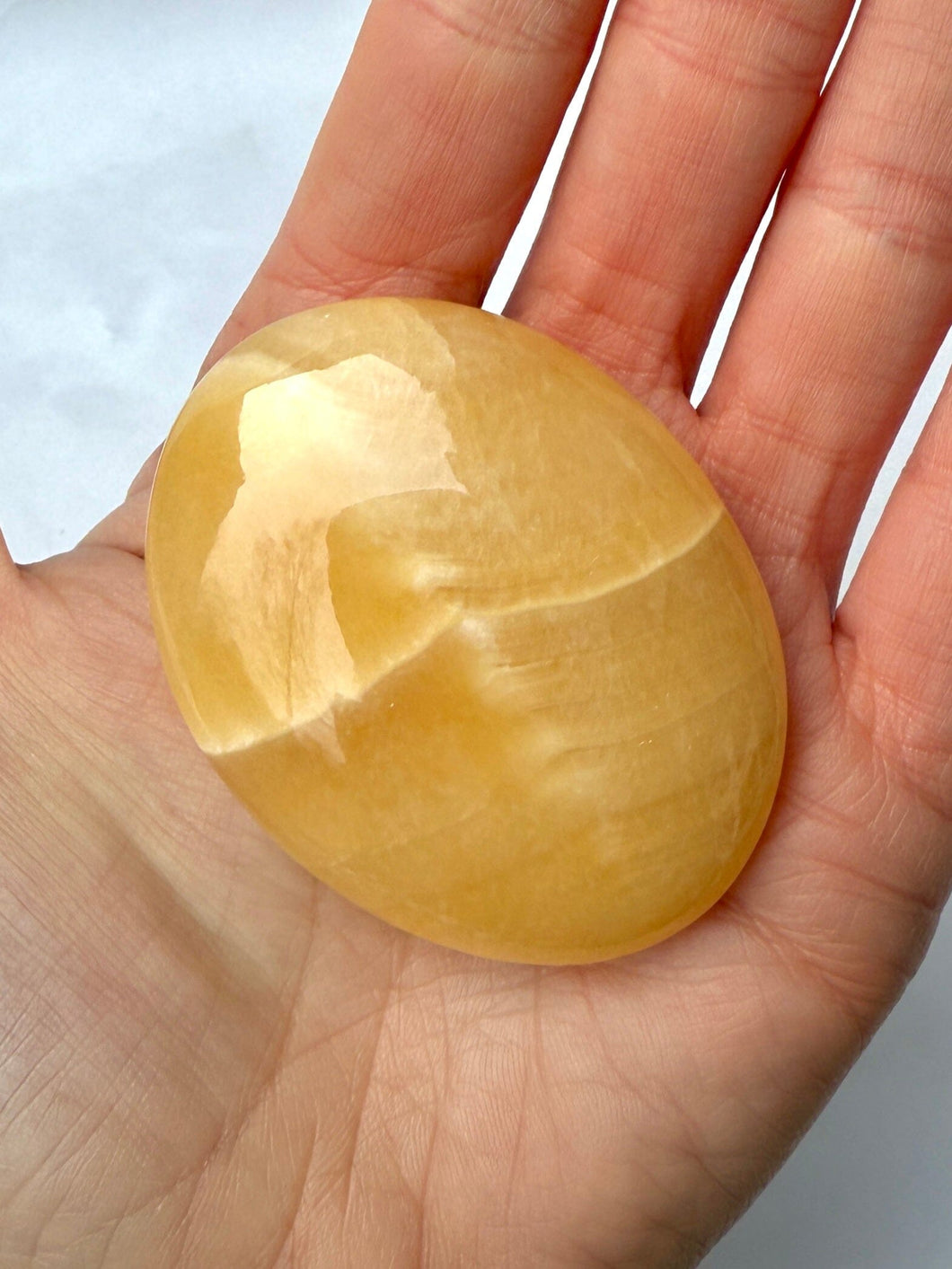 MANGO CALCITE PALM STONE (3) tumble stone The Crystal Avenues 