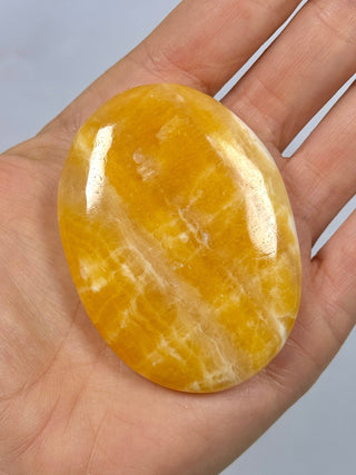 ORANGE CALCITE PALM STONE (1) tumble stone The Crystal Avenues 