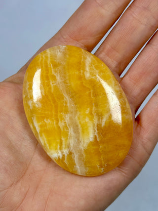 ORANGE CALCITE PALM STONE (2) tumble stone The Crystal Avenues 