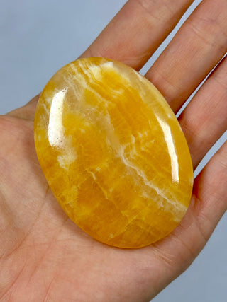ORANGE CALCITE PALM STONE (2) tumble stone The Crystal Avenues 