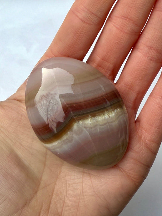 PINK BANDED ONYX PALM STONE (1) tumble stone The Crystal Avenues 